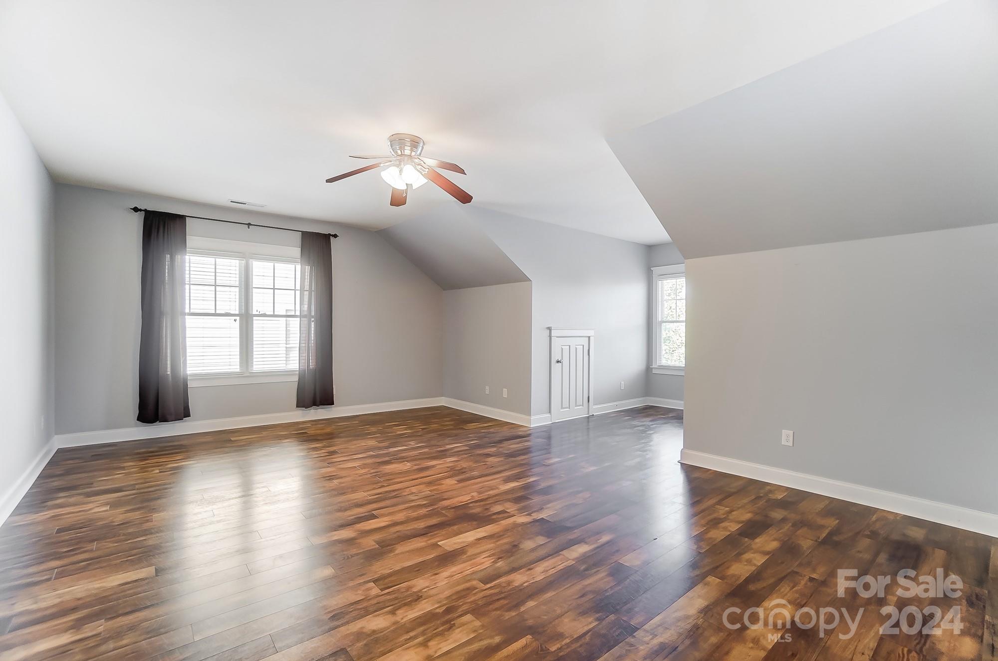 169 Mills Lane Fort Mill, SC 29708 - Photo 24 of 38 a view of empty room with wooden floor and fan