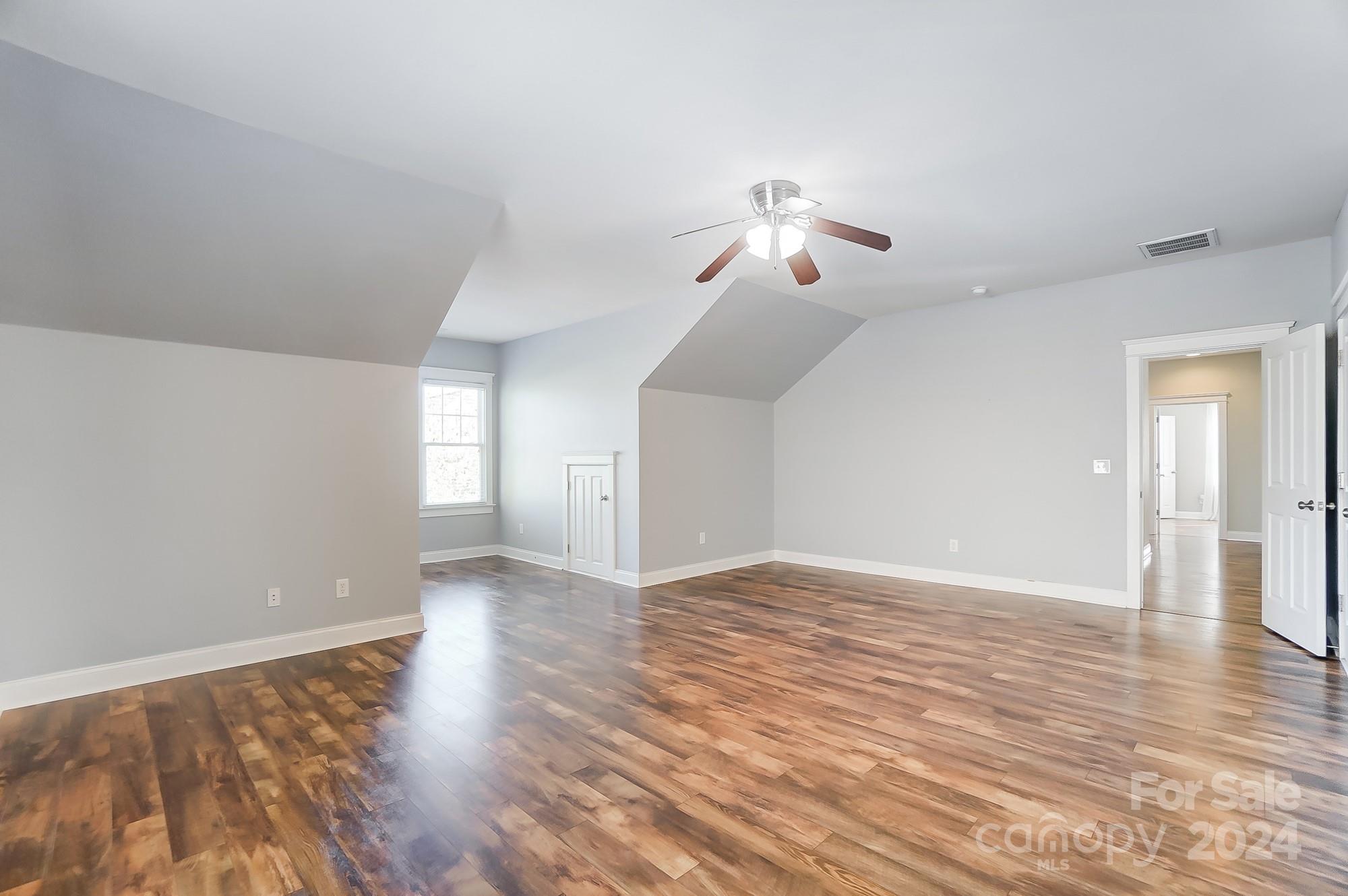 169 Mills Lane Fort Mill, SC 29708 - Photo 25 of 38 a view of empty room with wooden floor and ceiling fan