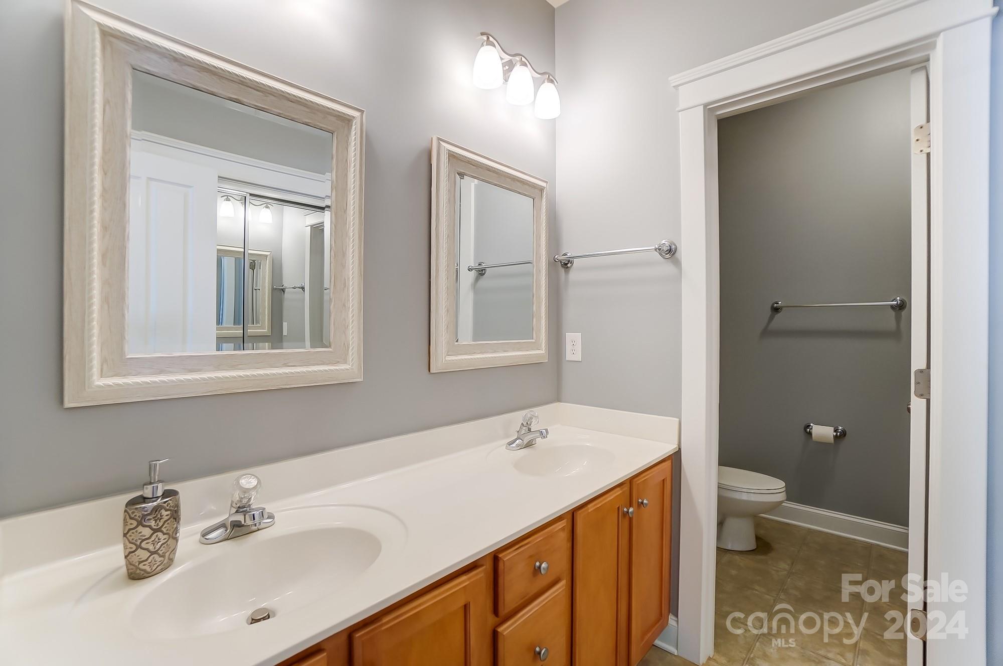 169 Mills Lane Fort Mill, SC 29708 - Photo 26 of 38 a bathroom with a sink a toilet and shower