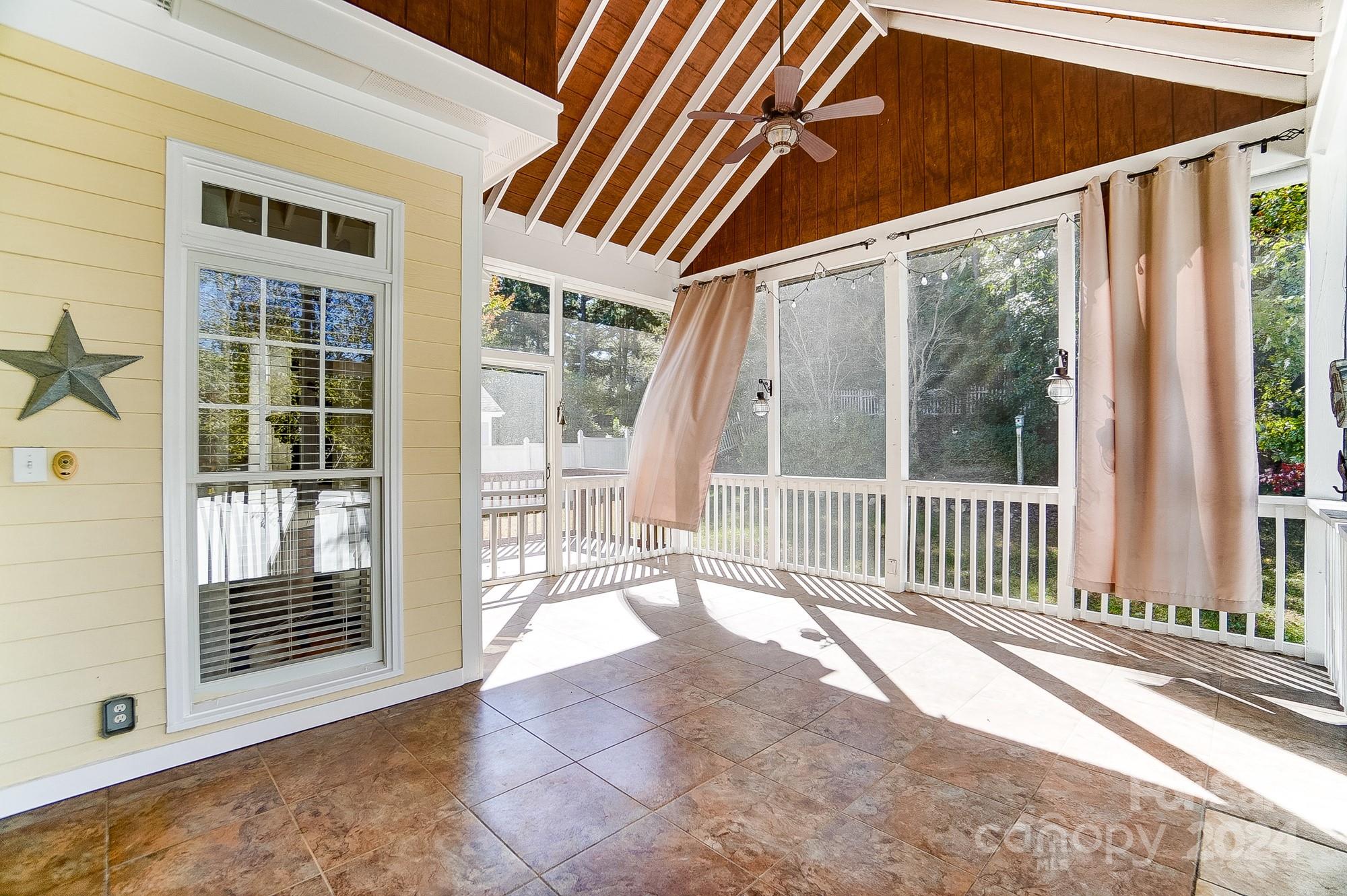 169 Mills Lane Fort Mill, SC 29708 - Photo 34 of 38 a view of a porch with wooden floor and a yard