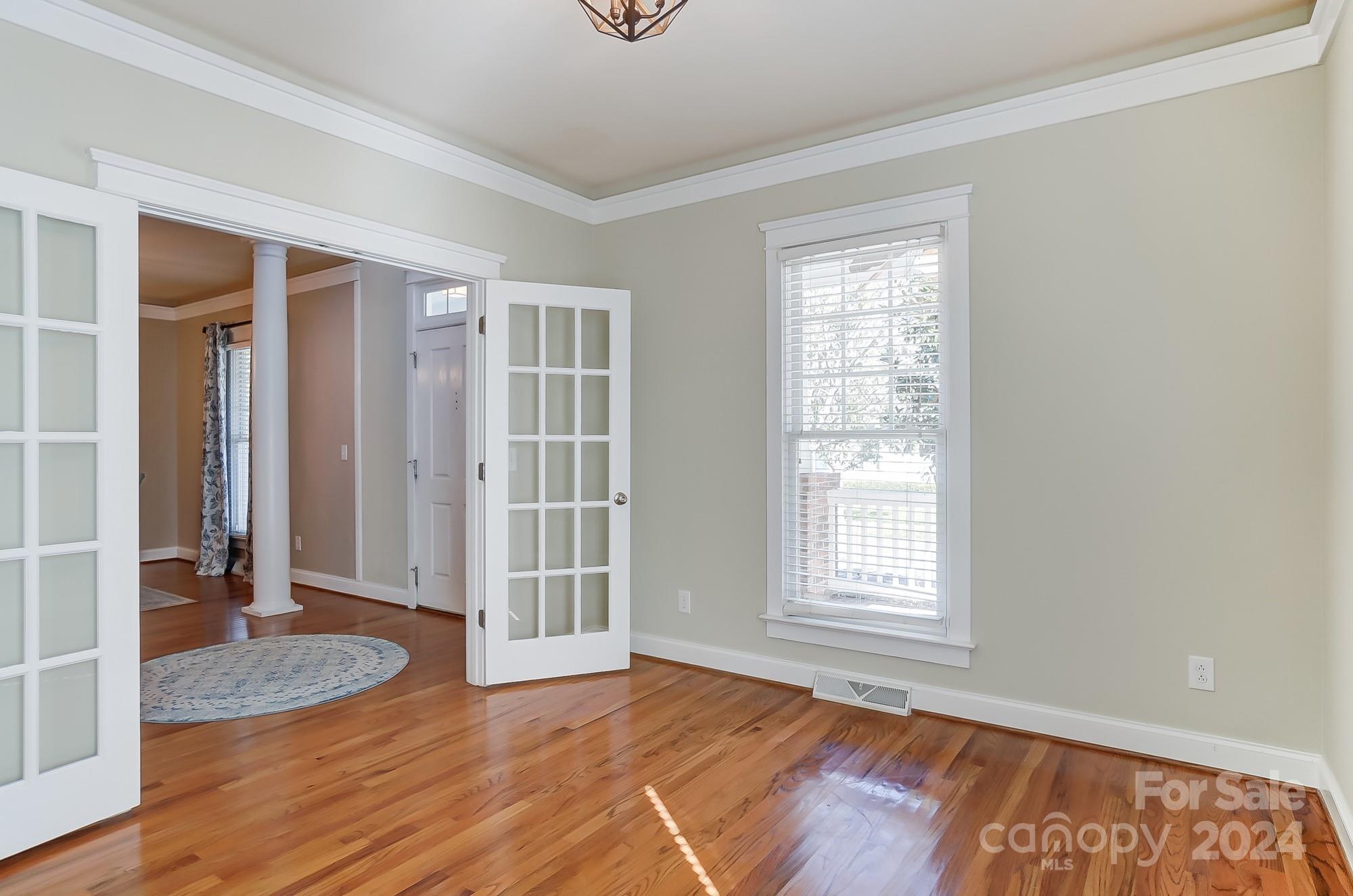 169 Mills Lane Fort Mill, SC 29708 - Photo 6 of 38 an empty room with wooden floor and windows