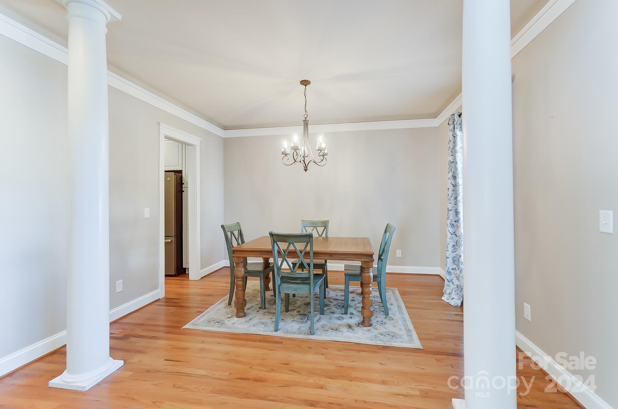 169 Mills Lane Fort Mill, SC 29708 - Photo 7 of 38 a view of a dining room with furniture and wooden floor