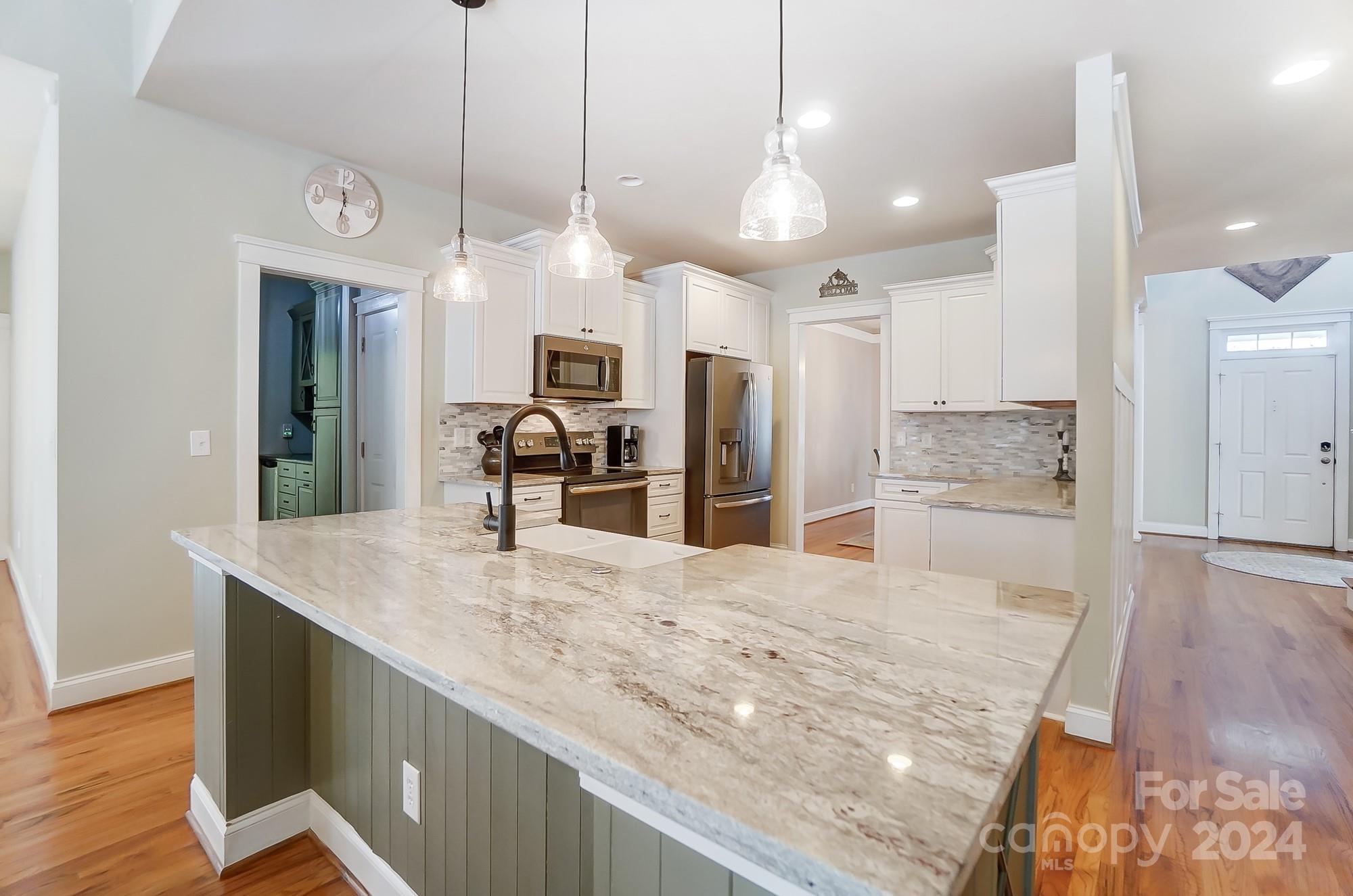 169 Mills Lane Fort Mill, SC 29708 - Photo 9 of 38 a kitchen with a refrigerator a sink and wooden floor