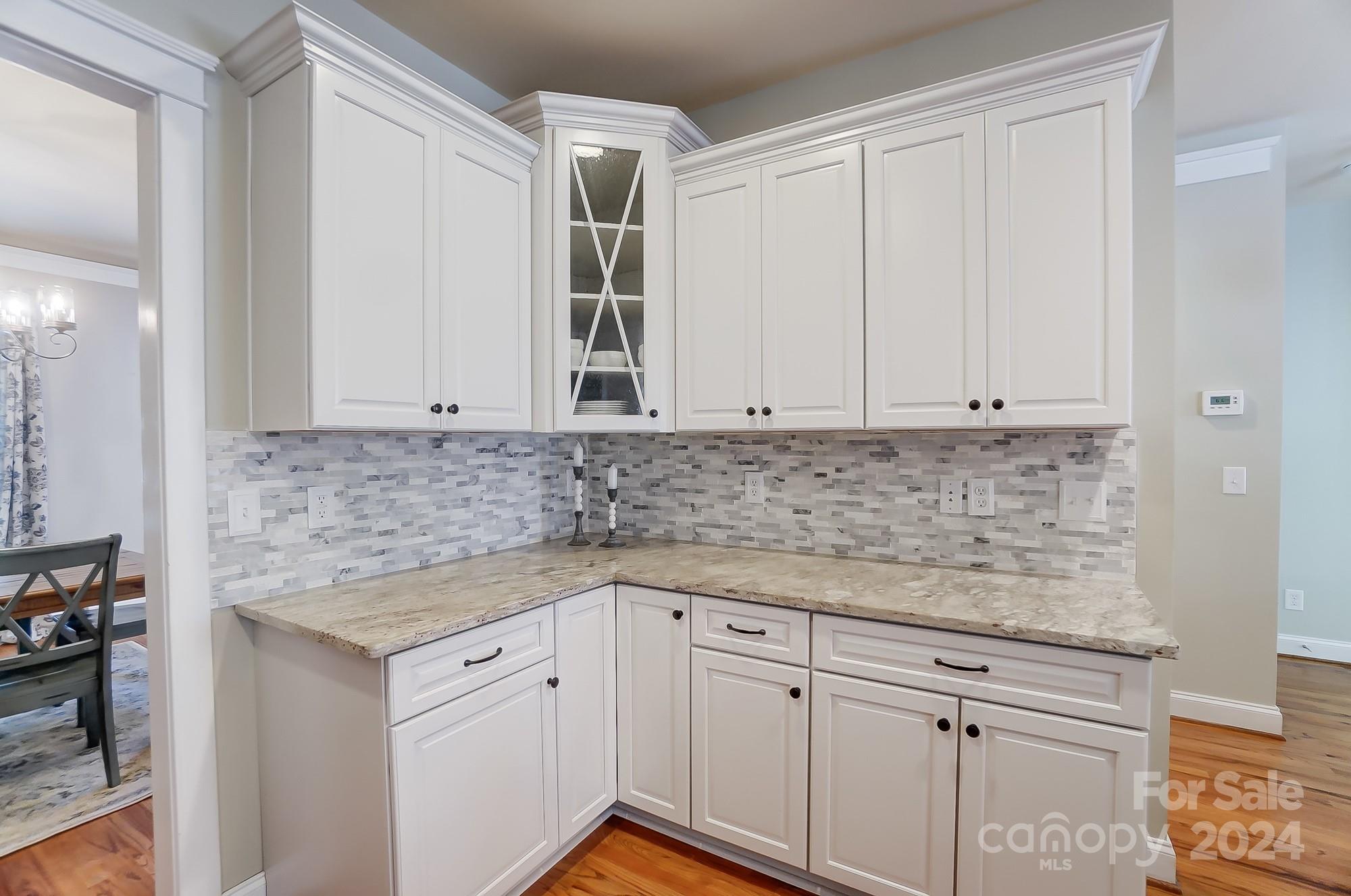 169 Mills Lane Fort Mill, SC 29708 - Photo 10 of 38 a kitchen with granite countertop white cabinets and white appliances