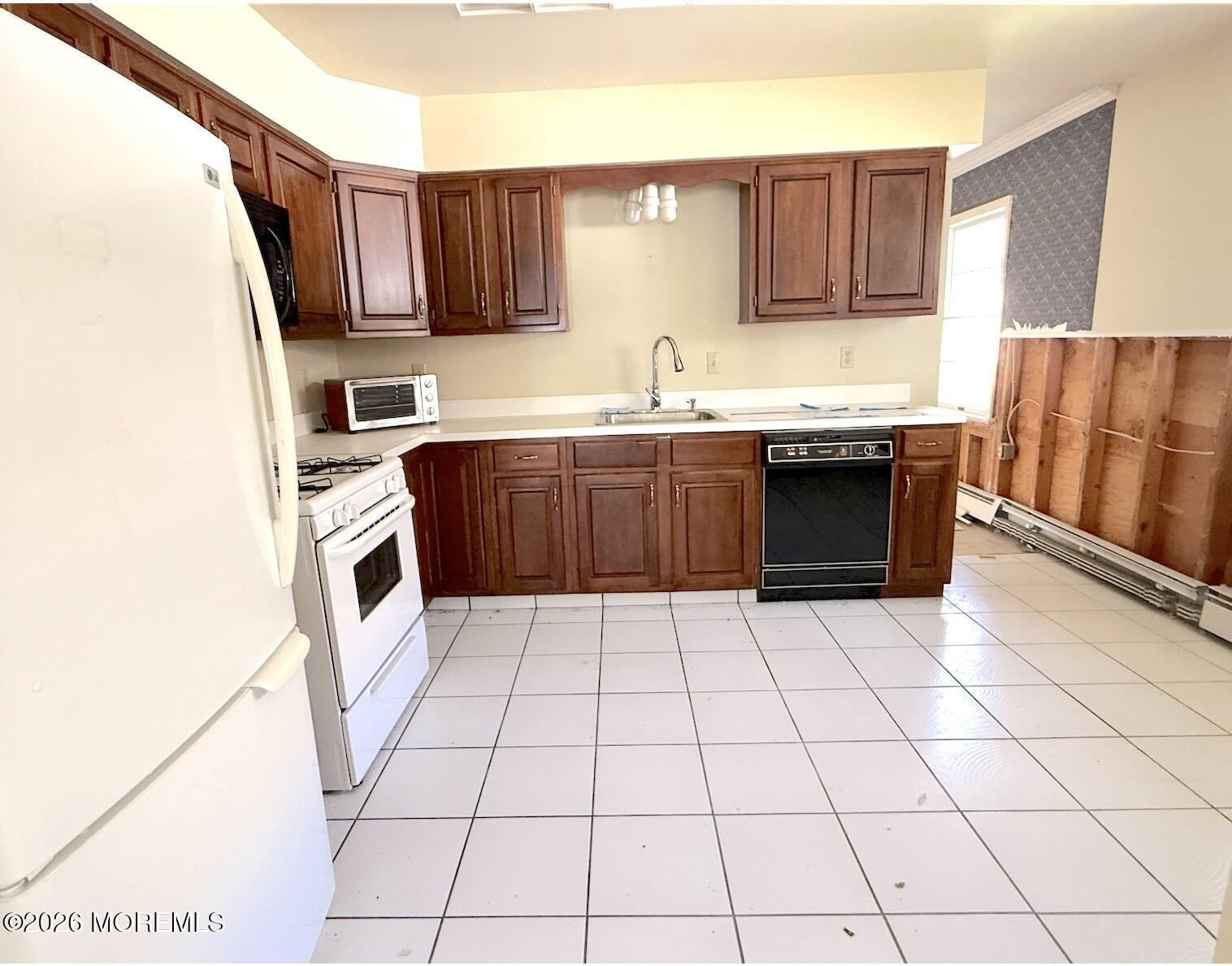 1575 Goldspire Road Toms River, NJ 08755 - Photo 7 of 16 a kitchen with stainless steel appliances a sink a stove a microwave and cabinets
