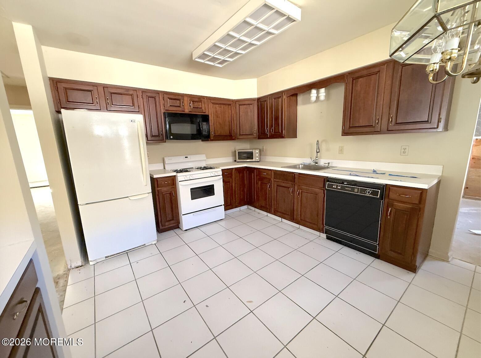 1575 Goldspire Road Toms River, NJ 08755 - Photo 8 of 16 a kitchen with stainless steel appliances granite countertop a sink and a refrigerator