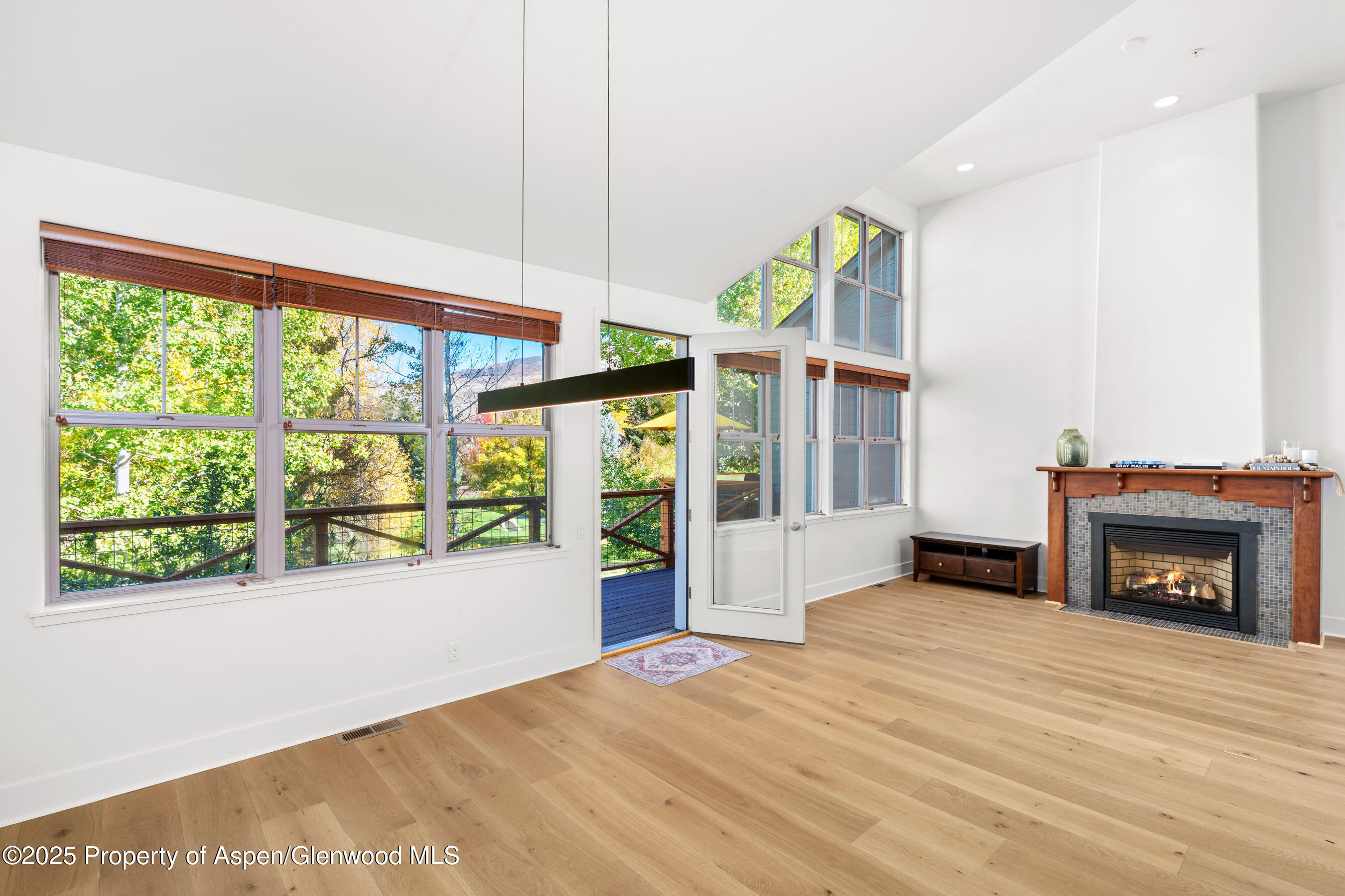 435 Jody Road Basalt, CO 81621 - Photo 4 of 29 a view of an empty room with a fireplace and a window