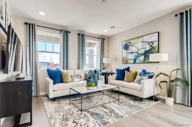 a kitchen with stainless steel appliances granite countertop a sink a stove a refrigerator cabinets and chairs