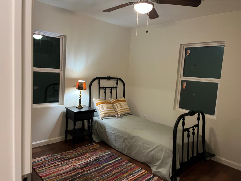 315 Hobson Street Weatherford, TX 76086 - Photo 11 of 24 Room featuring wood-finish flooring, white baseboards, and two single-hung windows
