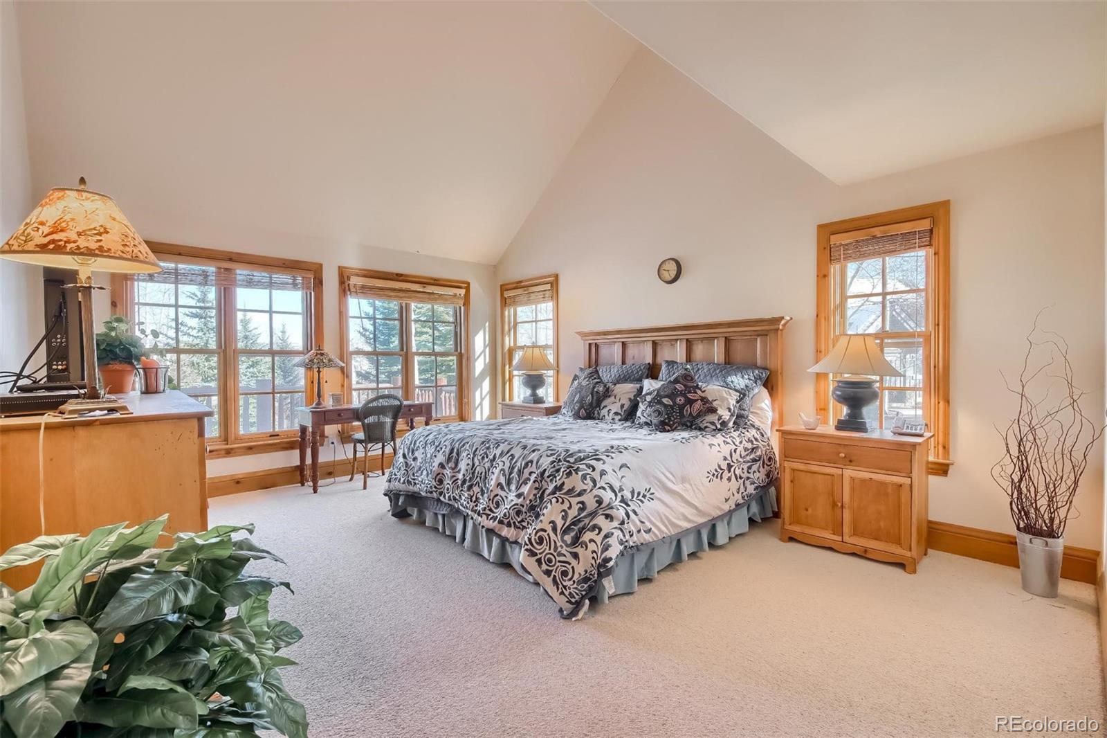 5 Fairway Lane Edwards, CO 81632 - Photo 11 of 34 a bedroom with a bed and large windows