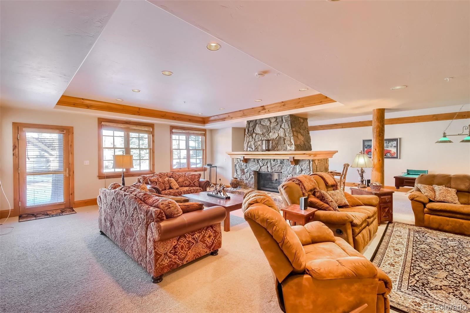 5 Fairway Lane Edwards, CO 81632 - Photo 22 of 34 a living room with furniture fireplace and a large window