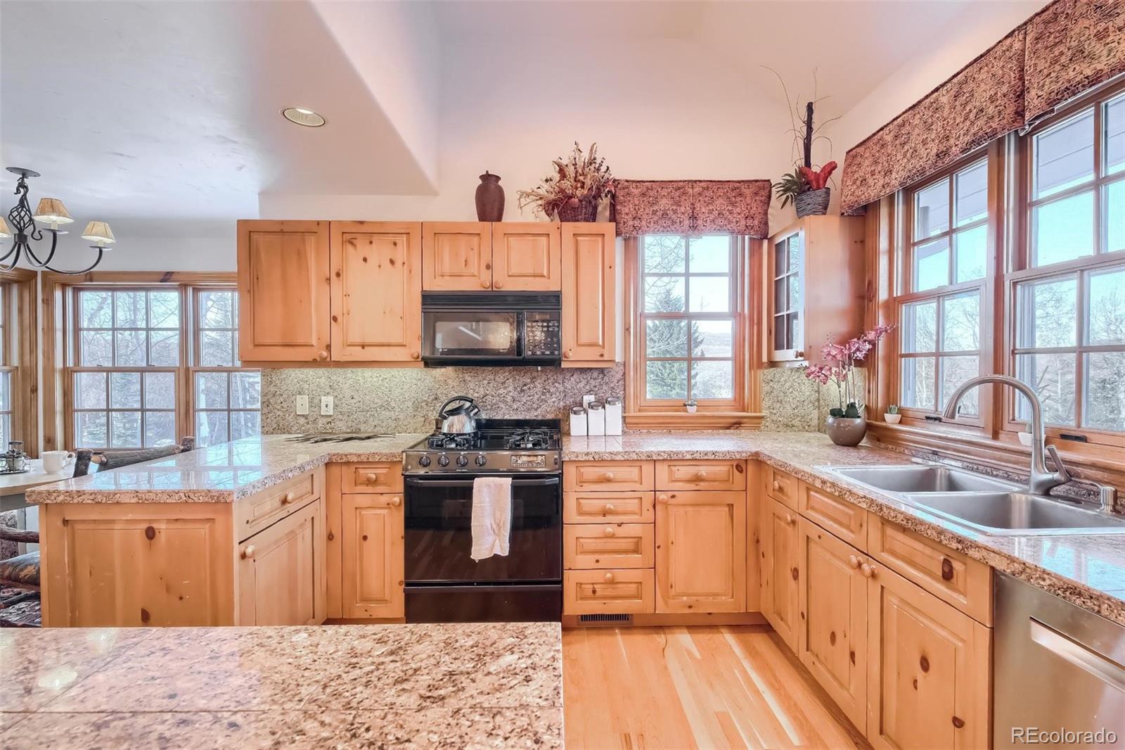 5 Fairway Lane Edwards, CO 81632 - Photo 6 of 34 a kitchen with stainless steel appliances granite countertop a sink stove and cabinets