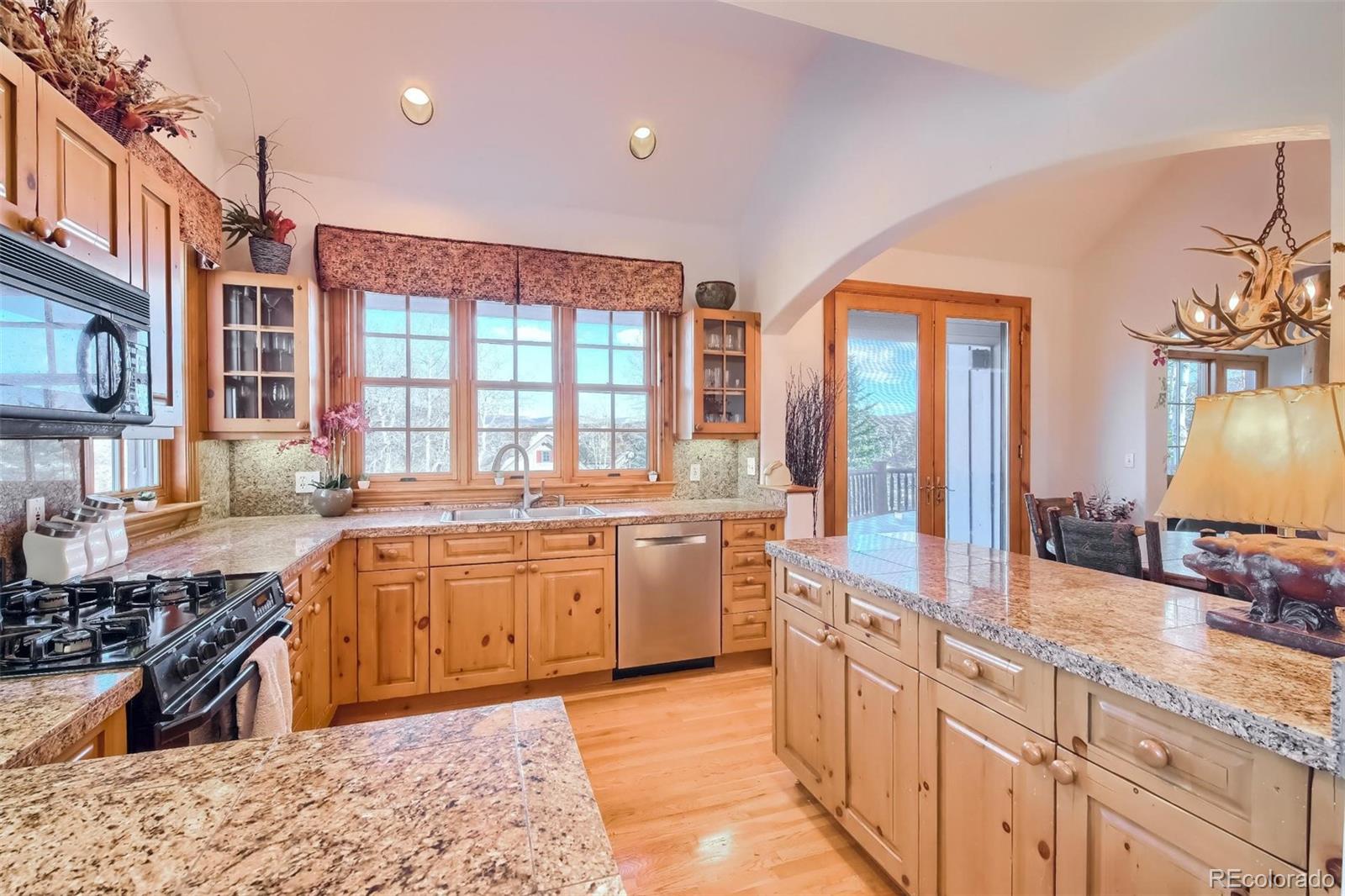 5 Fairway Lane Edwards, CO 81632 - Photo 7 of 34 a large kitchen with kitchen island granite countertop a large counter top stainless steel appliances and cabinets