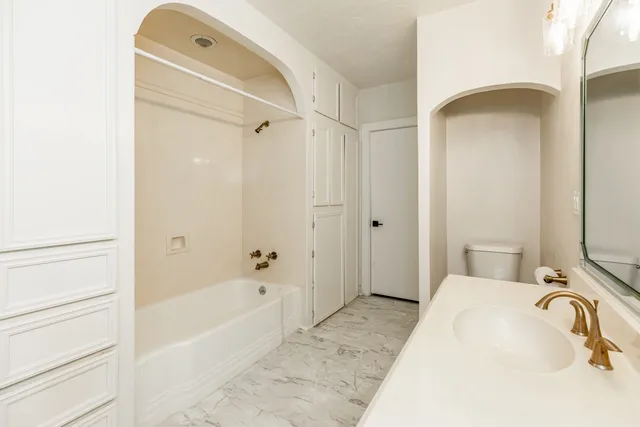 a bathroom with a tub and a sink