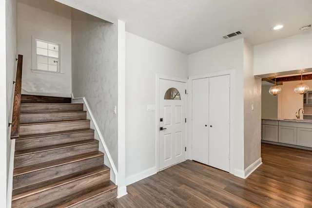 a view of a hallway with wooden floor and entryway