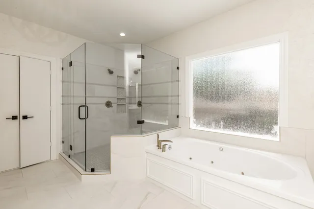 a bathroom with a bathtub and a shower