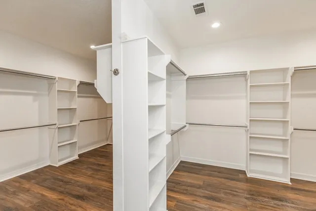 a view of a walk in closet with empty racks