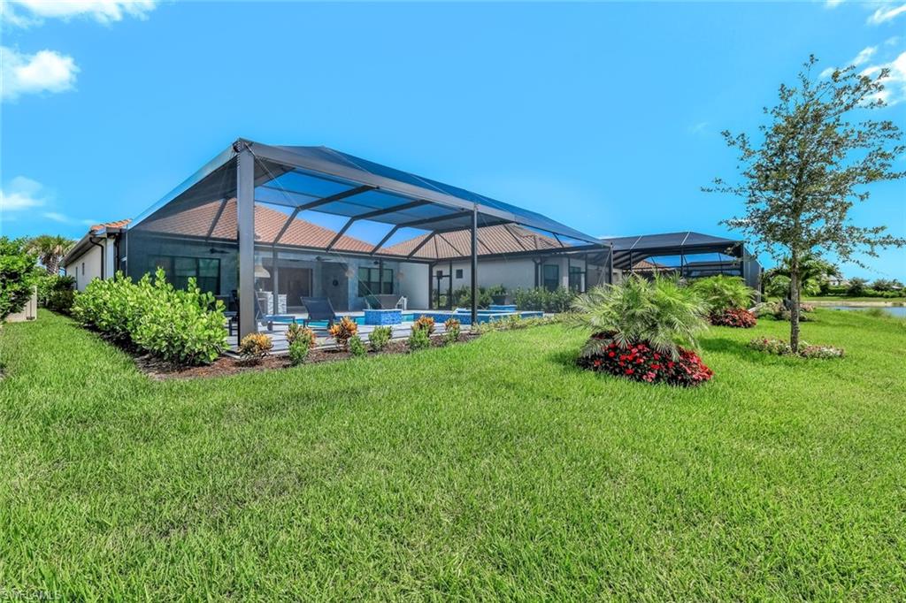 15495 Rio Ponace Court Naples, FL 34114 - Photo 42 of 43 a view of a house with a yard and sitting area