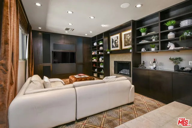 a living room with furniture and large windows