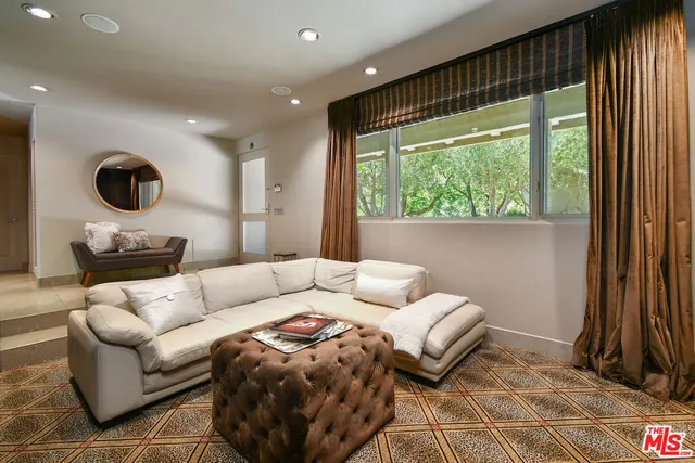 a living room with furniture fireplace and a flat screen tv