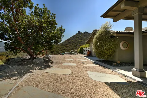 a large kitchen with stainless steel appliances granite countertop a stove a sink and a microwave