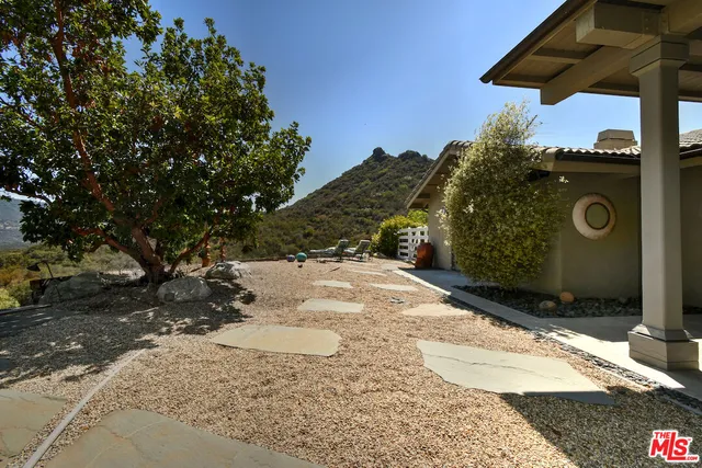 a large kitchen with stainless steel appliances granite countertop a stove a sink and a microwave