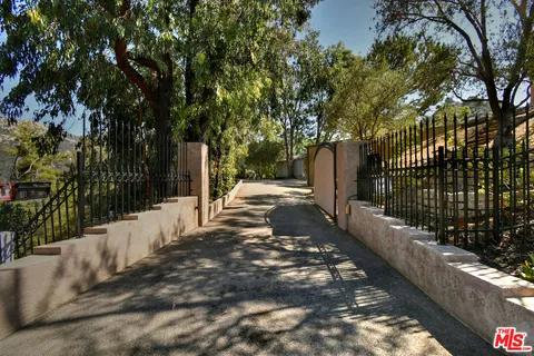 a view of a street with large trees