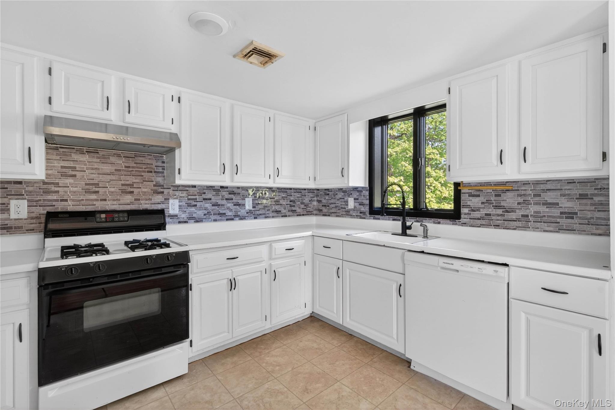 40 Felter Hill Road Monroe, NY 10950 - Photo 12 of 37 a kitchen with white cabinets and appliances