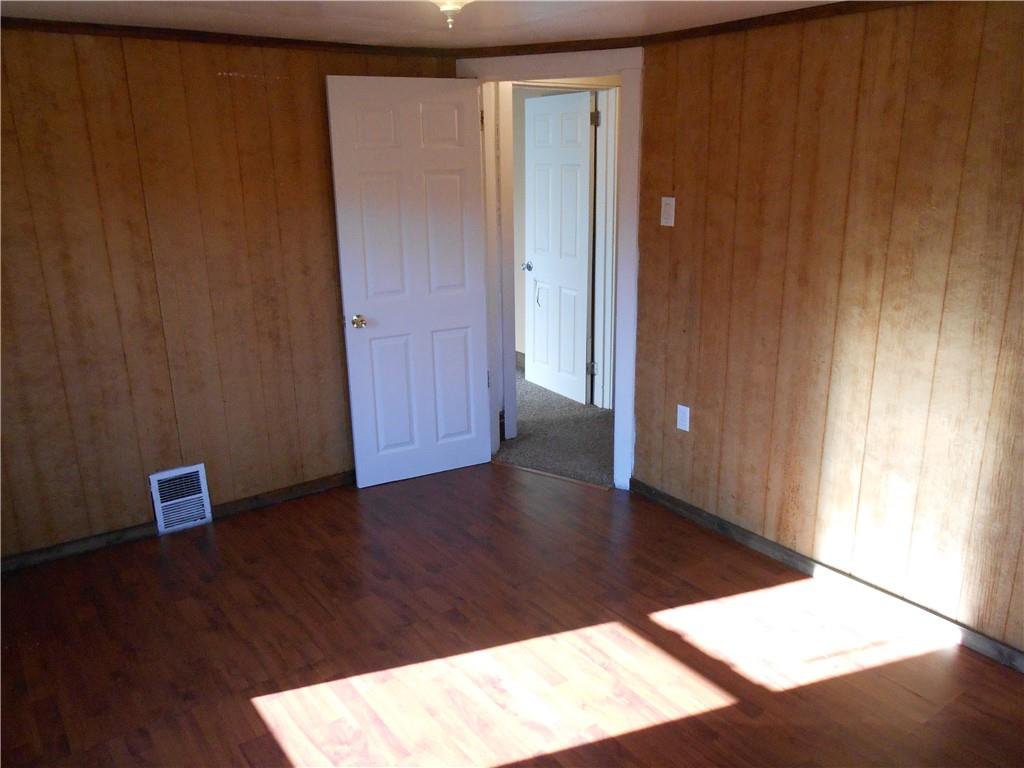 516 Oneida Street Monessen, PA 15062 - Photo 27 of 36 an empty room with wooden floor and windows