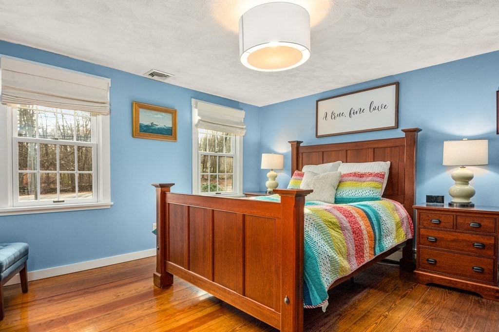 375 Ipswich Road Boxford, MA 01921 - Photo 26 of 42 a bedroom with a bed and wooden floor
