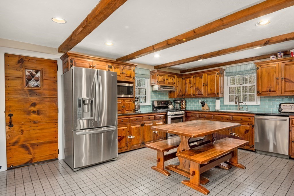 375 Ipswich Road Boxford, MA 01921 - Photo 4 of 42 a room with furniture a flat screen tv and kitchen view