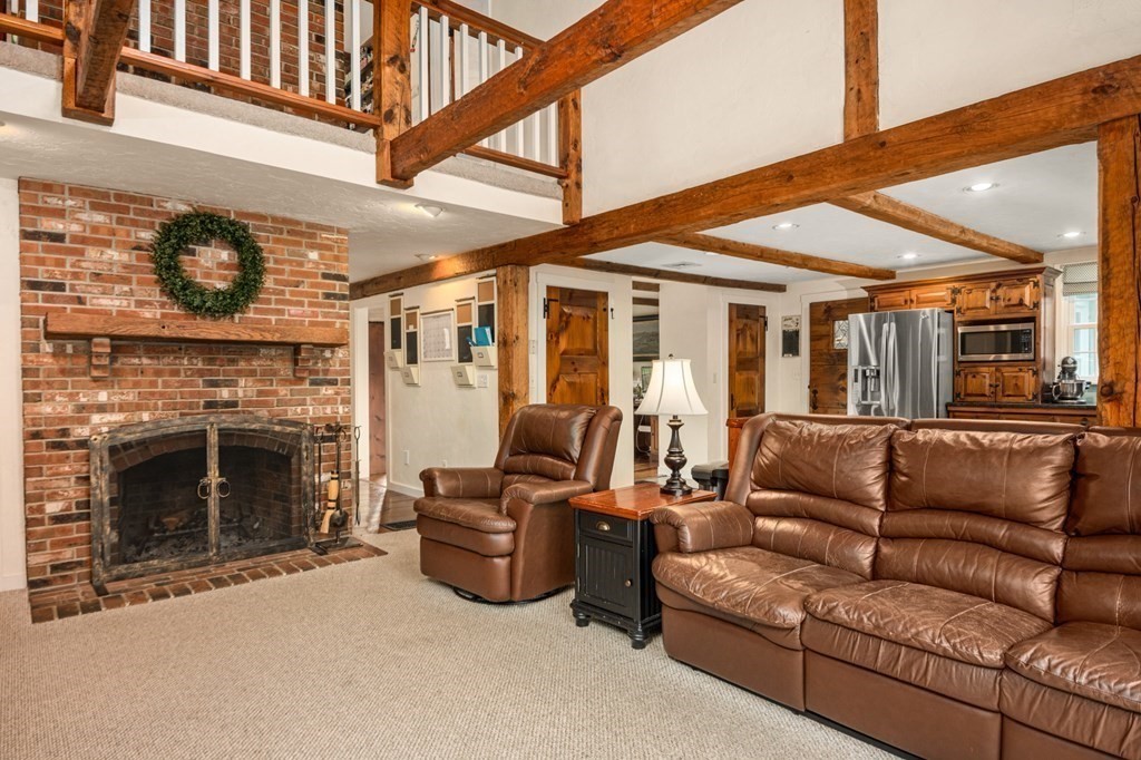 375 Ipswich Road Boxford, MA 01921 - Photo 9 of 42 a living room with furniture a fireplace and a wall painting