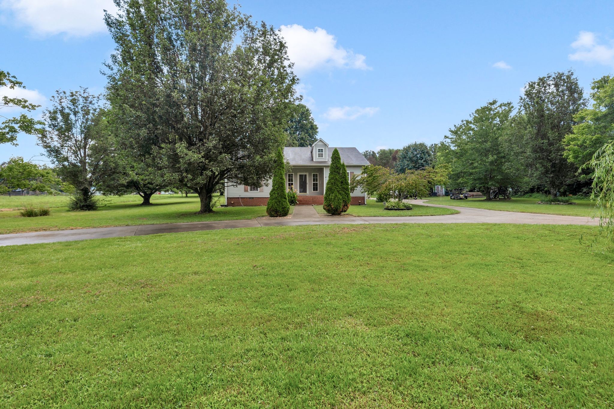876 Monument Road Summertown, TN 38483 - Photo 1 of 26 a front view of a building and a yard