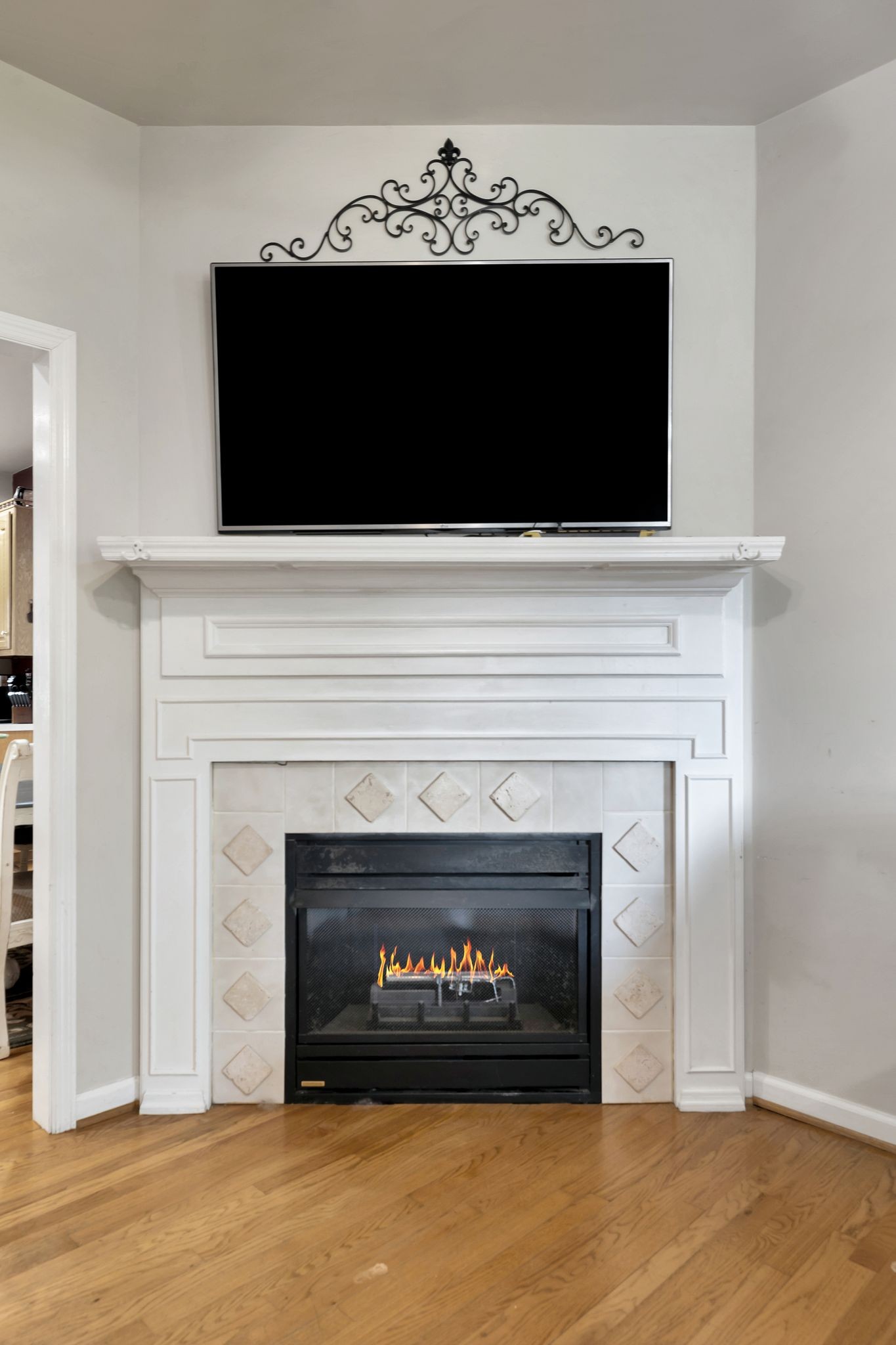 876 Monument Road Summertown, TN 38483 - Photo 11 of 26 a living room with a fireplace and a flat screen tv