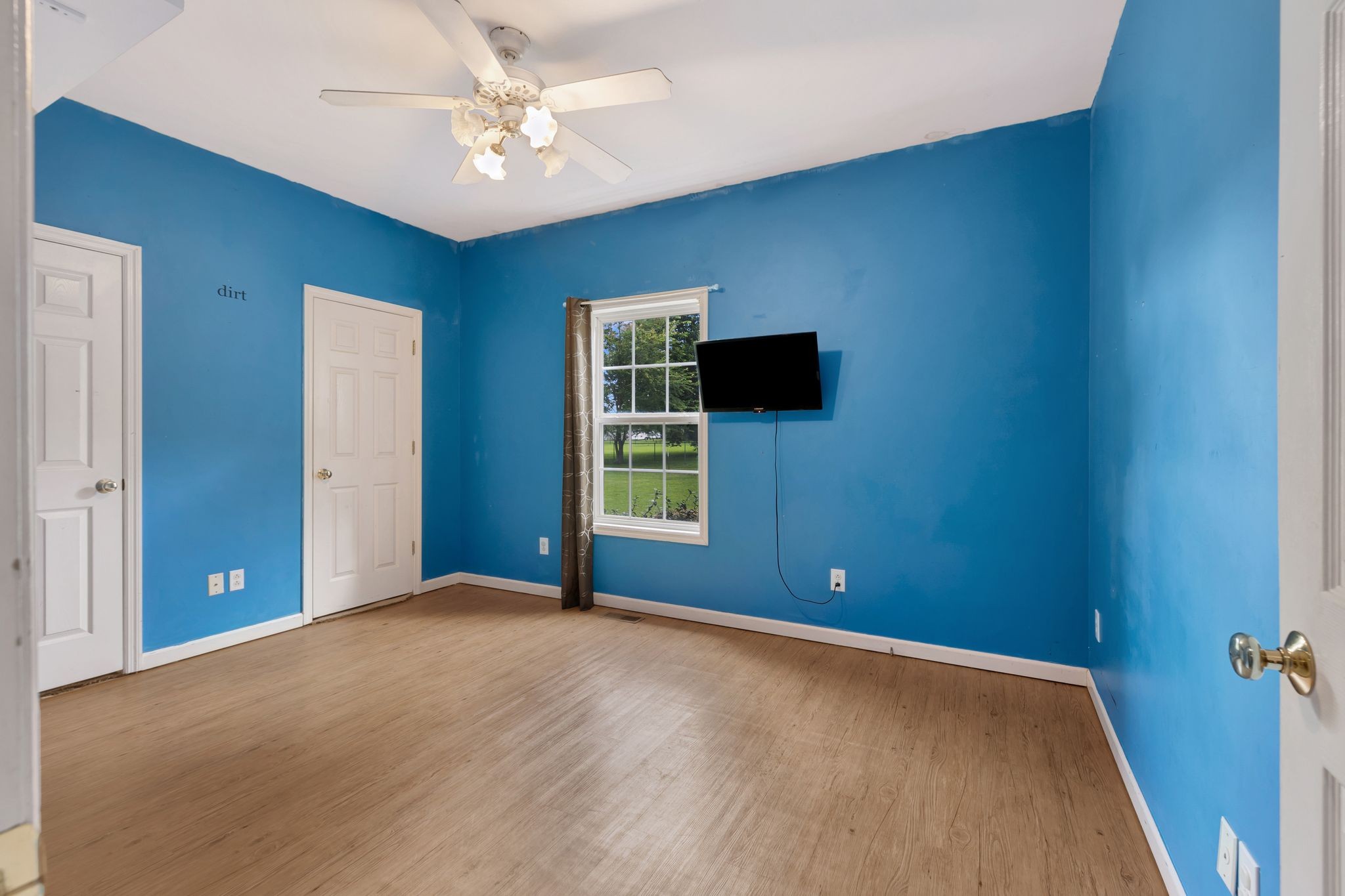 876 Monument Road Summertown, TN 38483 - Photo 19 of 26 wooden floor and window in an empty room