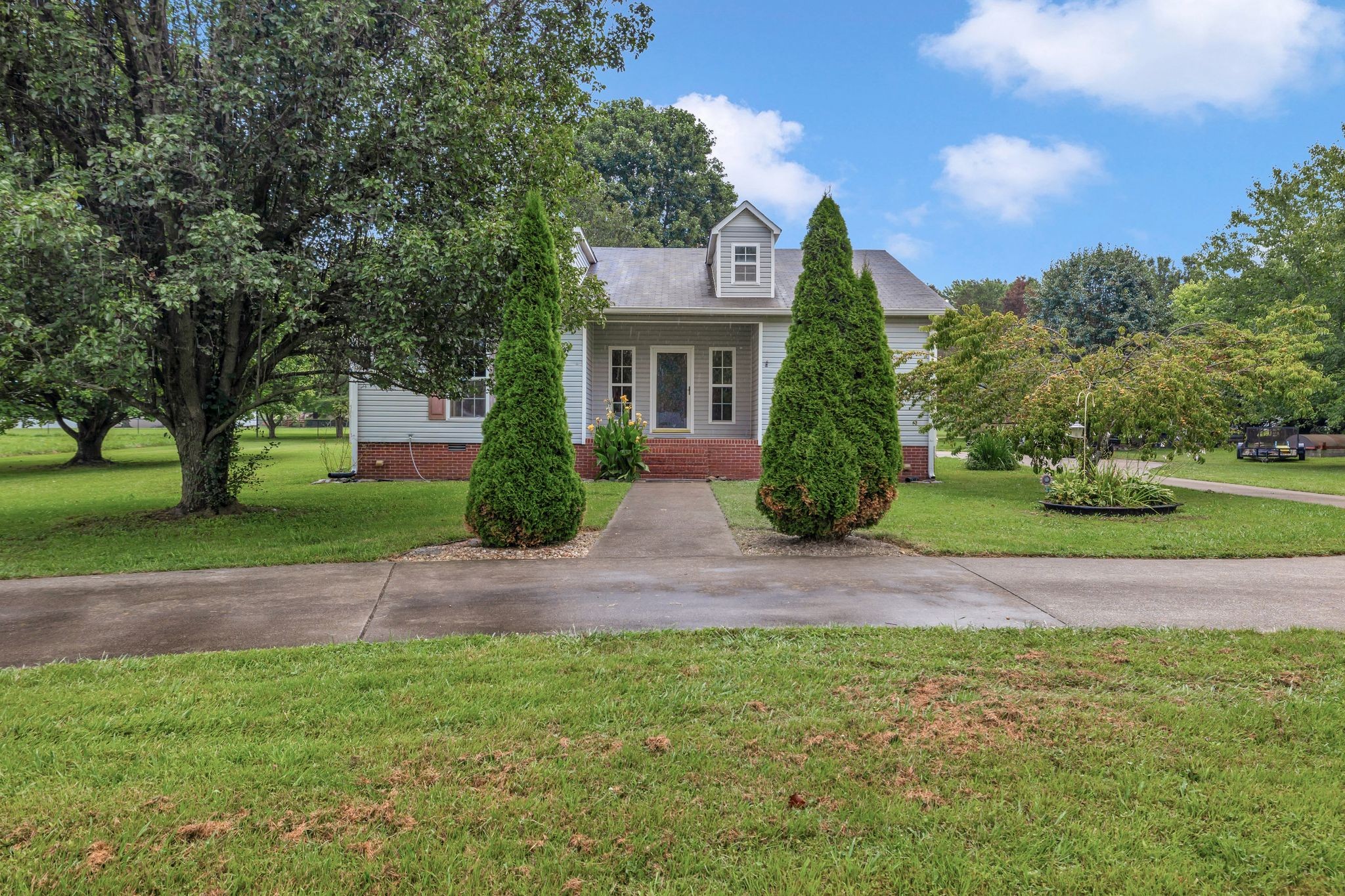 876 Monument Road Summertown, TN 38483 - Photo 2 of 26 a front view of a house with garden