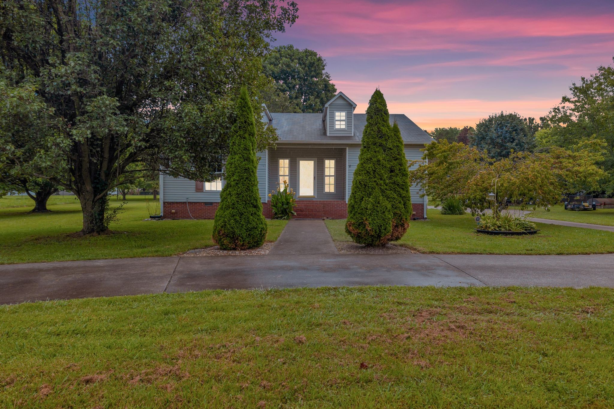 876 Monument Road Summertown, TN 38483 - Photo 3 of 26 a front view of a house with garden