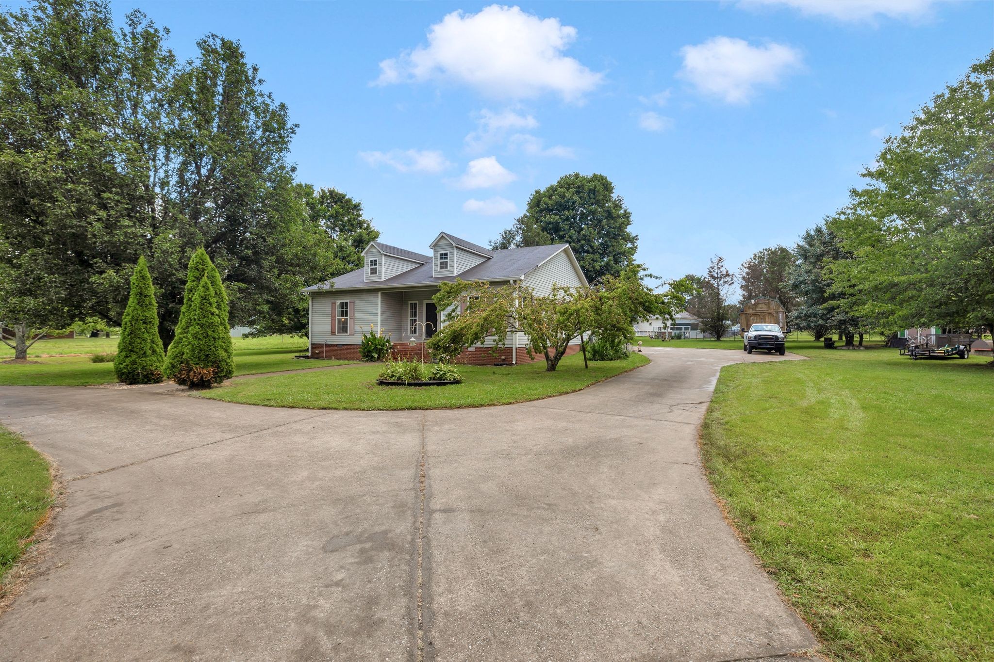 876 Monument Road Summertown, TN 38483 - Photo 6 of 26 a view of a house with a big yard plants and trees