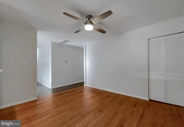 a view of an empty room with wooden floor