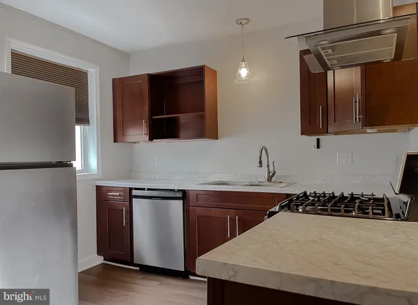 a kitchen with a sink and a refrigerator