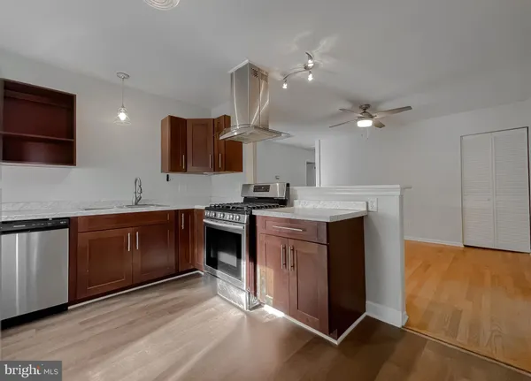 a kitchen with stainless steel appliances granite countertop a sink and a stove