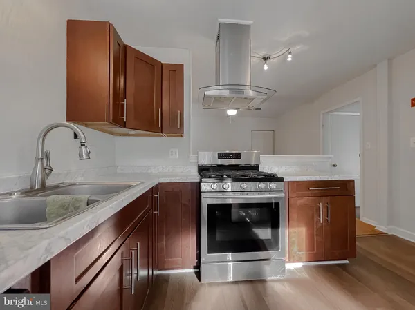 a kitchen with stainless steel appliances granite countertop a stove and a sink