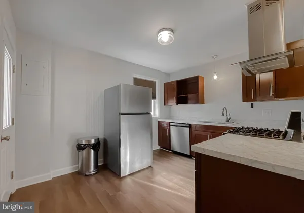 a kitchen with a refrigerator and a sink
