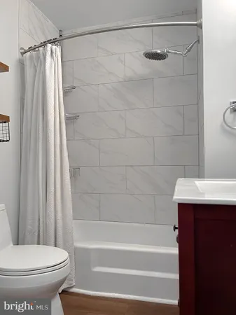 a bathroom with a shower and a toilet