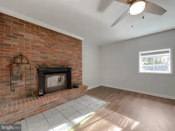 a view of empty room with a fireplace