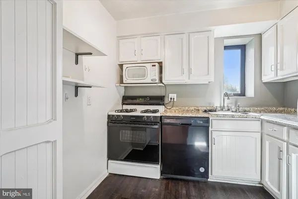 a bed room with a bed and a chair