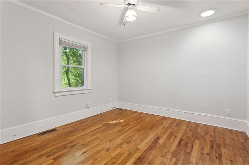 385 Sunset Drive Athens, GA 30606 - Photo 25 of 48 wooden floor in an empty room with a window