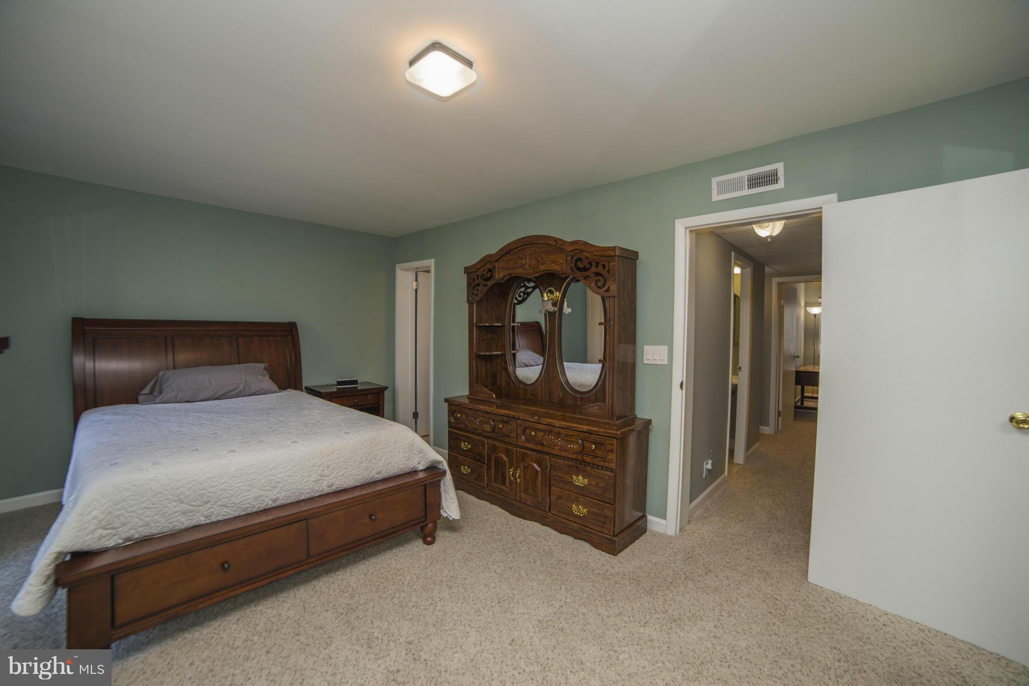 1613 Valencia Way Reston, VA 20190 - Photo 12 of 29 a bedroom with a bed and a dresser