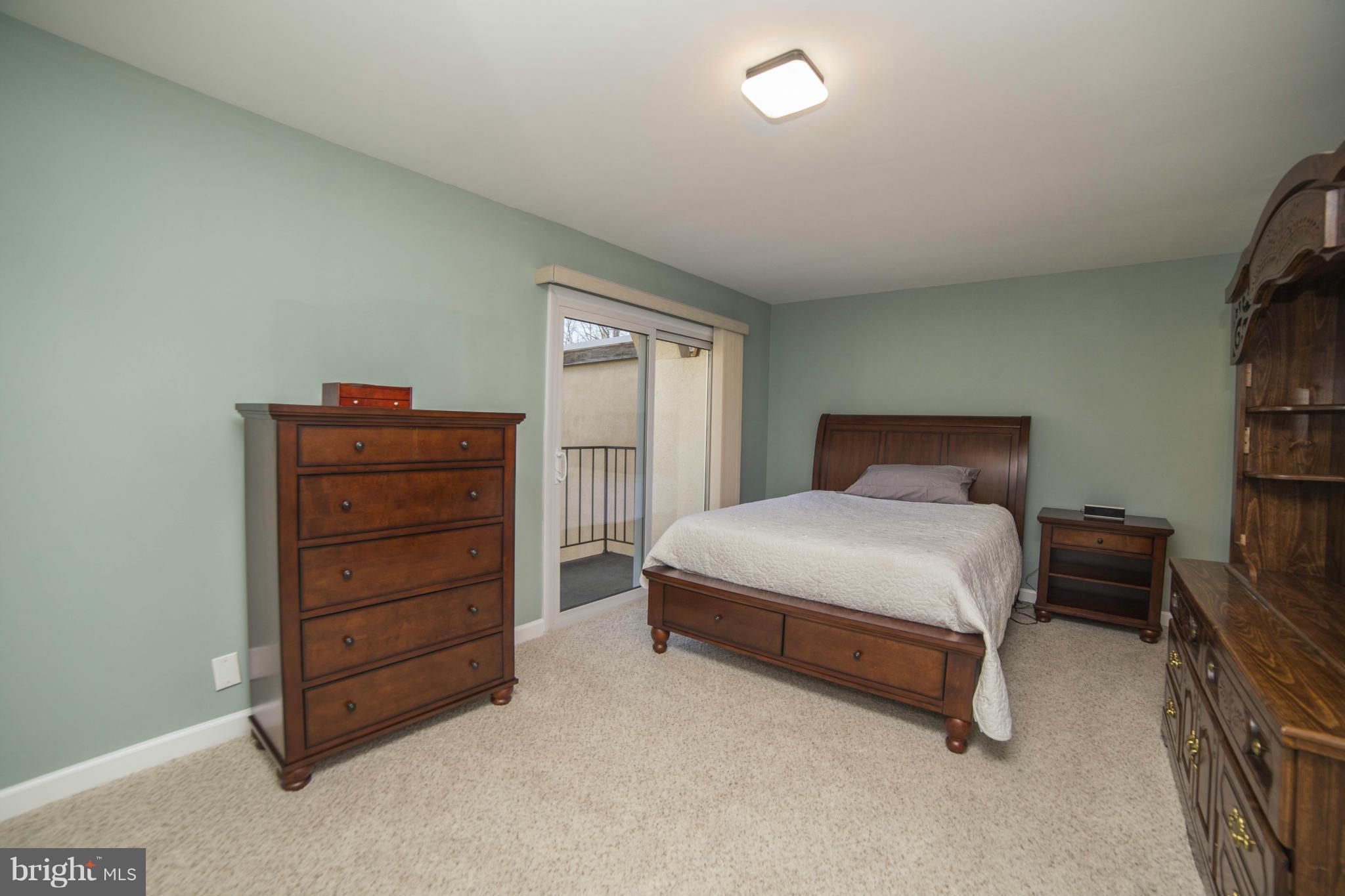 1613 Valencia Way Reston, VA 20190 - Photo 13 of 29 a bedroom with a bed and furniture