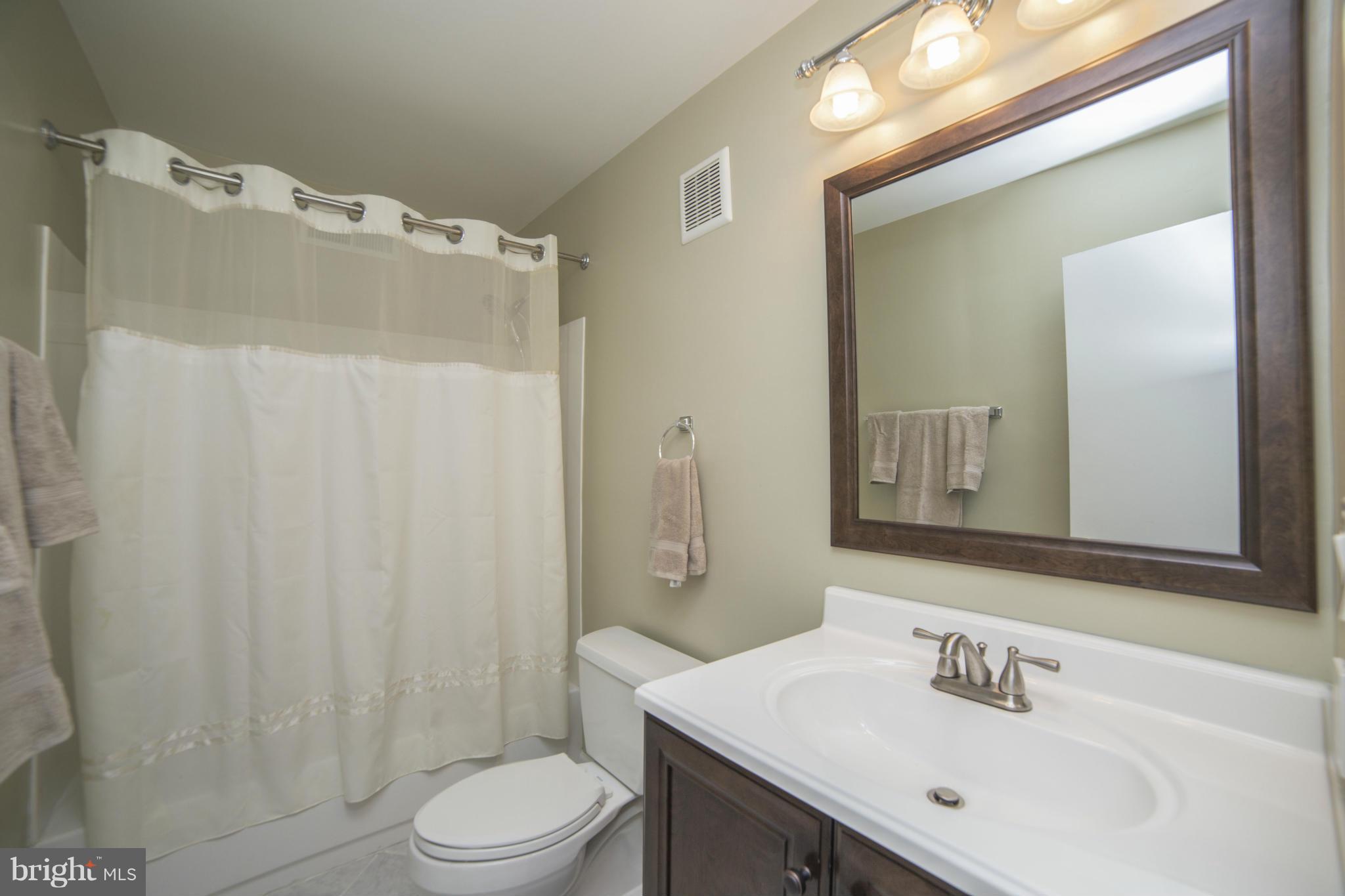 1613 Valencia Way Reston, VA 20190 - Photo 14 of 29 a bathroom with a sink toilet and shower